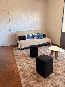 a room with a bed with blue pillows on it at Casa do Mauro in Foz do Iguaçu +19 photos