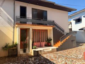a house with a staircase and a balcony at Casa do Mauro in Foz do Iguaçu