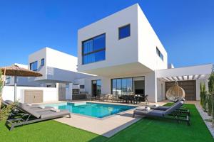 ein weißes Haus mit Pool und Rasen in der Unterkunft Princess Anne Luxury Villa - Large Pool in Protaras