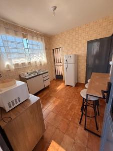 a kitchen with a white refrigerator and a table at Casa do Mauro in Foz do Iguaçu +20 photos