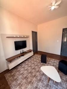 a living room with a flat screen tv on a wall at Casa do Mauro in Foz do Iguaçu