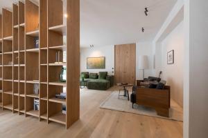 a living room with wooden book shelves and a couch at Design Apartment Carina in Lech am Arlberg