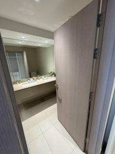 a bathroom with a door leading to a sink at Family-Friendly 2BR on Yas Playground access in Yas Island +8 photos