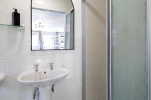 a bathroom with a sink and a mirror at Sea Bliss in Kenton on Sea