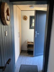 einen Flur mit blauer Tür und einem Tisch in der Unterkunft Ferienhaus für 2 Personen ca 40 m in Vichtenstein, Oberösterreich Donau Oberösterreich in Vichtenstein