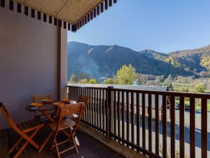 a table and chairs on a balcony with a view at Appartement charmant pour 5 à Loudenvielle, proche télécabine - FR-1-695-91 in Loudenvielle