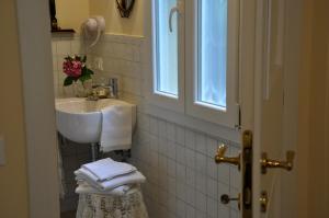 a white bathroom with a sink and a sink at Casa Ardizzoni in Bologna