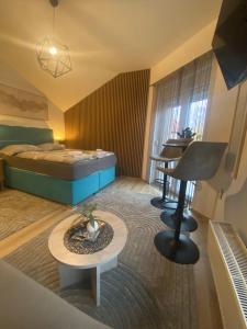 a hotel room with a bed and a table at Luma 2 in Osijek