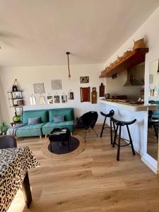 a living room with a green couch and a table at Casa Halcón in Jávea
