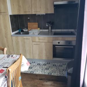 a small kitchen with a sink and a stove at Chez SamB in Lussac-les-Châteaux