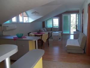 a living room with a couch and a table at Apartment Forest and Lake in Lagadin