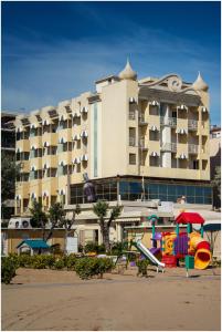 a large building with a playground in front of it at AmbientHotels Panoramic in Rimini