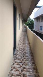 a hallway of a building with a brick walkway at Padma residency in Coimbatore