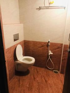 a bathroom with a toilet and a shower at Padma residency in Coimbatore
