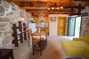 a kitchen and dining room with a table and chairs at Ferienhaus In Dobropoljana Mit Privatem Pool in Dobropoljana