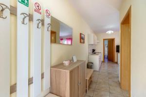 a room with a hallway with a counter and a kitchen at Appartement Casper Mit Terrasse, Garten Und Grill in Veli Lošinj