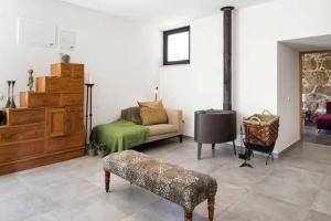 a living room with a couch and a stove at Renoviertes Landhaus Für 4 Personen In Tondela in Tondela