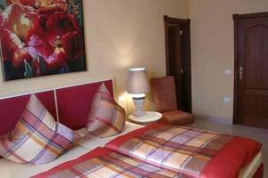 a bedroom with a bed and a lamp and a chair at Marbella Guia Isora in Guía de Isora +31 photos