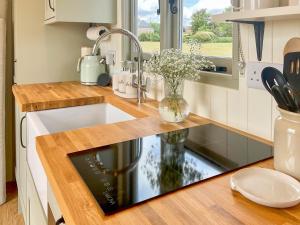 a kitchen counter with a sink and a window at The Coop in Broadway