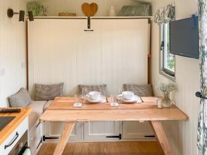 a wooden table in a tiny house with a tableablish at The Coop in Broadway
