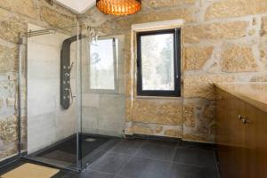 a bathroom with a shower and a window at Renoviertes Landhaus Für 7 Personen In Tondela in Tondela +30 photos