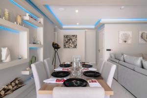 a dining room with a table and a couch at Rua Luxury Villa in Alykes +27 photos