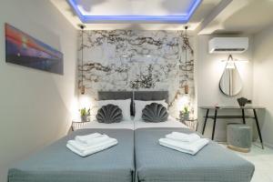 a bedroom with a bed with two towels on it at Rua Luxury Villa in Zakynthos +26 photos