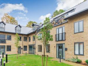 an exterior view of a brick apartment building with a yard at The Loft At St John's in York