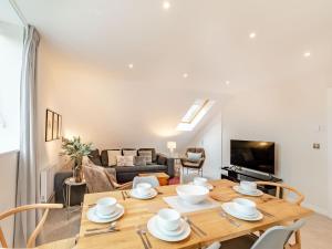 ein Wohnzimmer mit Tisch und Couch in der Unterkunft The Loft At St John's in York