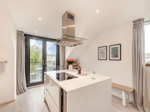 a kitchen with a white counter top and a stove at The Loft At St John's in York