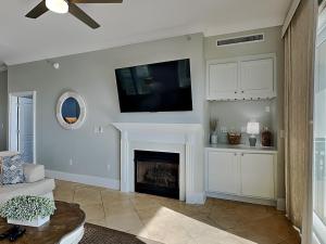 a living room with a fireplace and a flat screen tv at Adagio #105B in Santa Rosa Beach