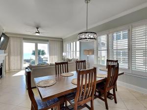 a kitchen and dining room with a table and chairs at Adagio #105B in Santa Rosa Beach