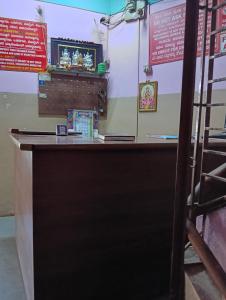 a counter in a restaurant with signs on the wall at V R S Dormitory in Hubli