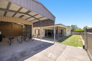 a garage with bikes parked outside of a house at Sea La Vie in Arakoon
