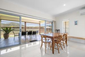 a dining room with a table and chairs at Sea La Vie in Arakoon