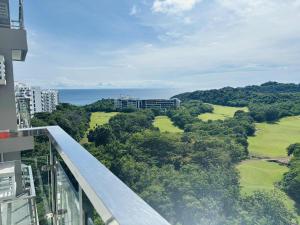 a balcony of a building with a view of a golf course at Ocean Verde Suite Boracay in Boracay