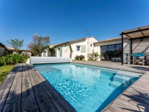 a swimming pool in the backyard of a house at Maison familiale avec piscine pour 9 personnes - FR-1-835-4 in Le Bois-Plage-en-Ré