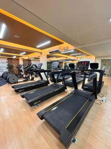 a gym with a row of treadmills and machines at Ocean Verde Suite Boracay in Boracay