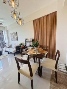 a living room with a dining table and chairs at Ocean Verde Suite Boracay in Boracay