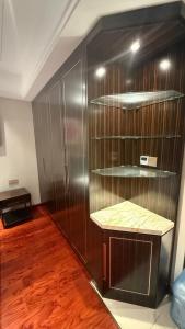 a room with a wooden wall with a shelf at NAGA Frontier Apartment in Vientiane +14 photos