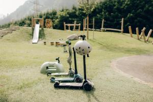 a figurine of a dog on a scooter in a park at Neuhaus Zillertal Resort in Mayrhofen