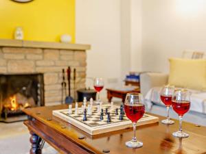 a chess game with wine glasses on a table at 3 Bed in Haselbury Plucknett 83943 in Haselbury Plucknett +7 photos