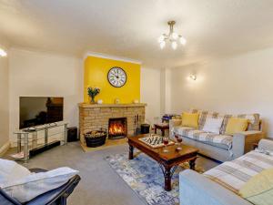 a living room with a couch and a fireplace at 3 Bed in Haselbury Plucknett 83943 in Haselbury Plucknett