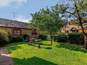 a yard with a table and chairs in front of a house at 3 Bed in Haselbury Plucknett 83943 in Haselbury Plucknett