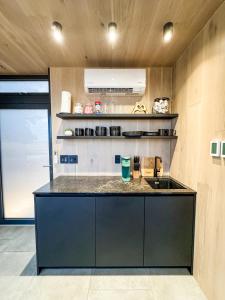 a kitchen with a black counter and a sink at Perseus at The Retreat in Fredericksburg +12 photos