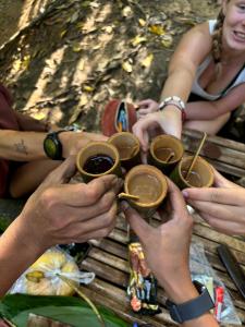 a group of people holding up cups of coffee at Cha homestay in Phanom