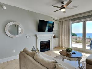 a living room with a couch and a fireplace at Adagio #105B in Santa Rosa Beach