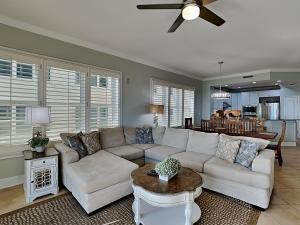 a living room with a white couch and a table at Adagio #105B in Santa Rosa Beach