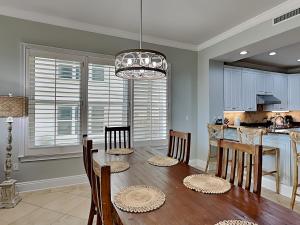 a dining room and kitchen with a table and chairs at Adagio #105B in Santa Rosa Beach +36 photos