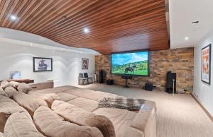 a large living room with a large couch and a flat screen tv at Aspen Silverado in Aspen Valley Hospital Heliport